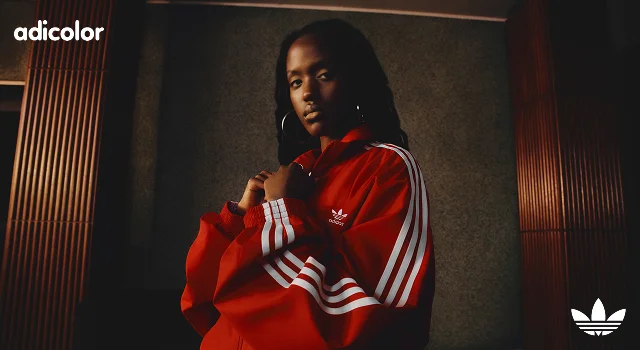 Woman wearing red adicolor track jacket