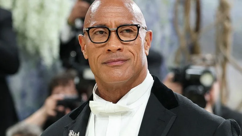 Image may contain: Dwayne Johnson, Blazer, Clothing, Coat, Jacket, Adult, Person, Face, and Head