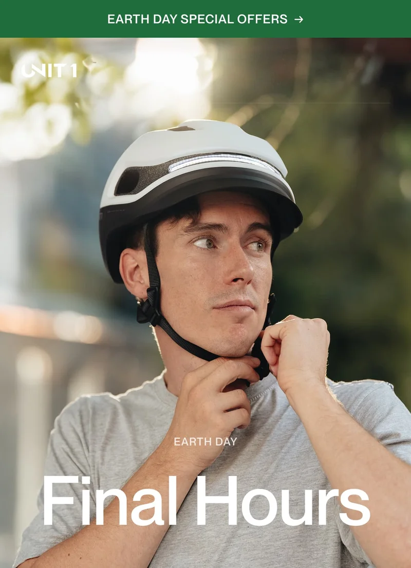 Man adjusting his UNIT 1 smart helmet strap, ready to ride safely and worry-free on Earth Day