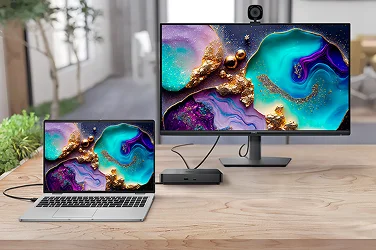A Dell laptop computer, monitor and webcam connected by a dock.