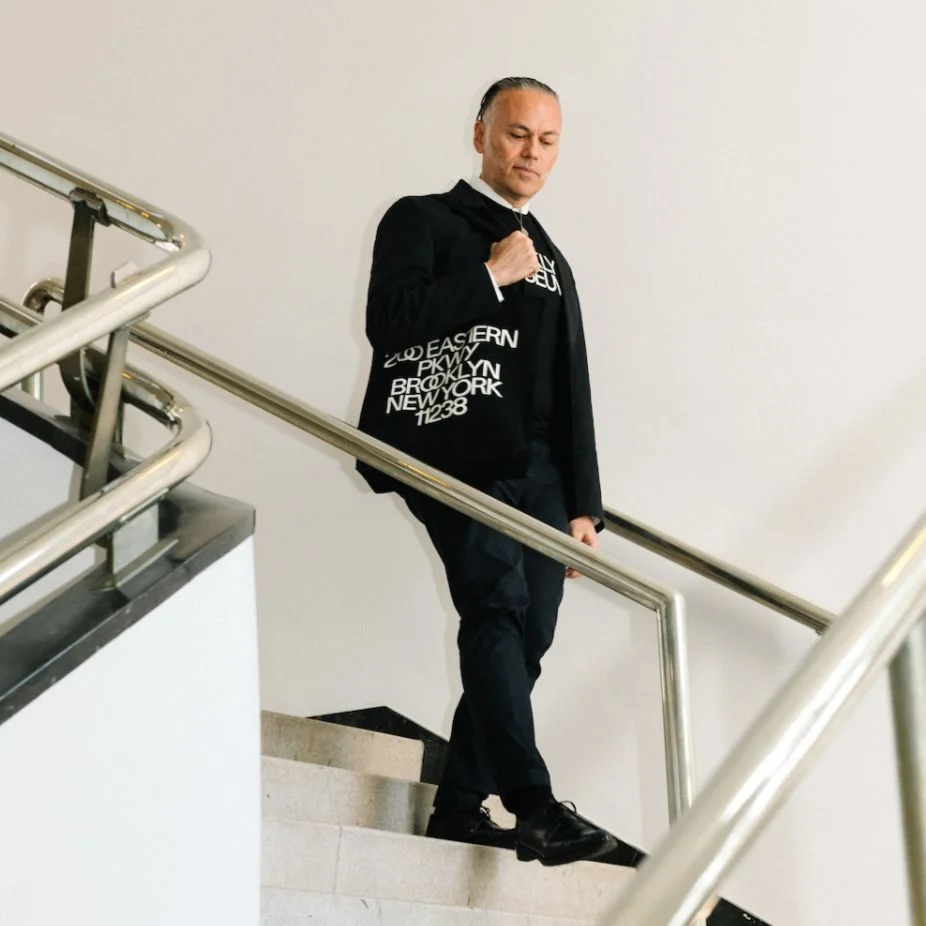 person walking down the stairs with Brooklyn Museum Tote