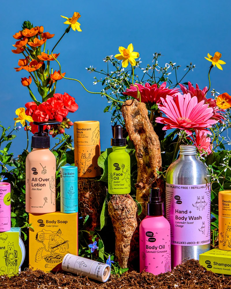 A collection of colorful products arranged in a pile with many flowers