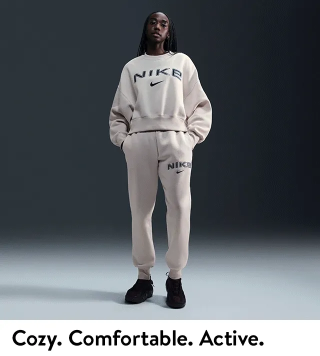 A woman wearing Nike fleece sweatshirt and joggers.