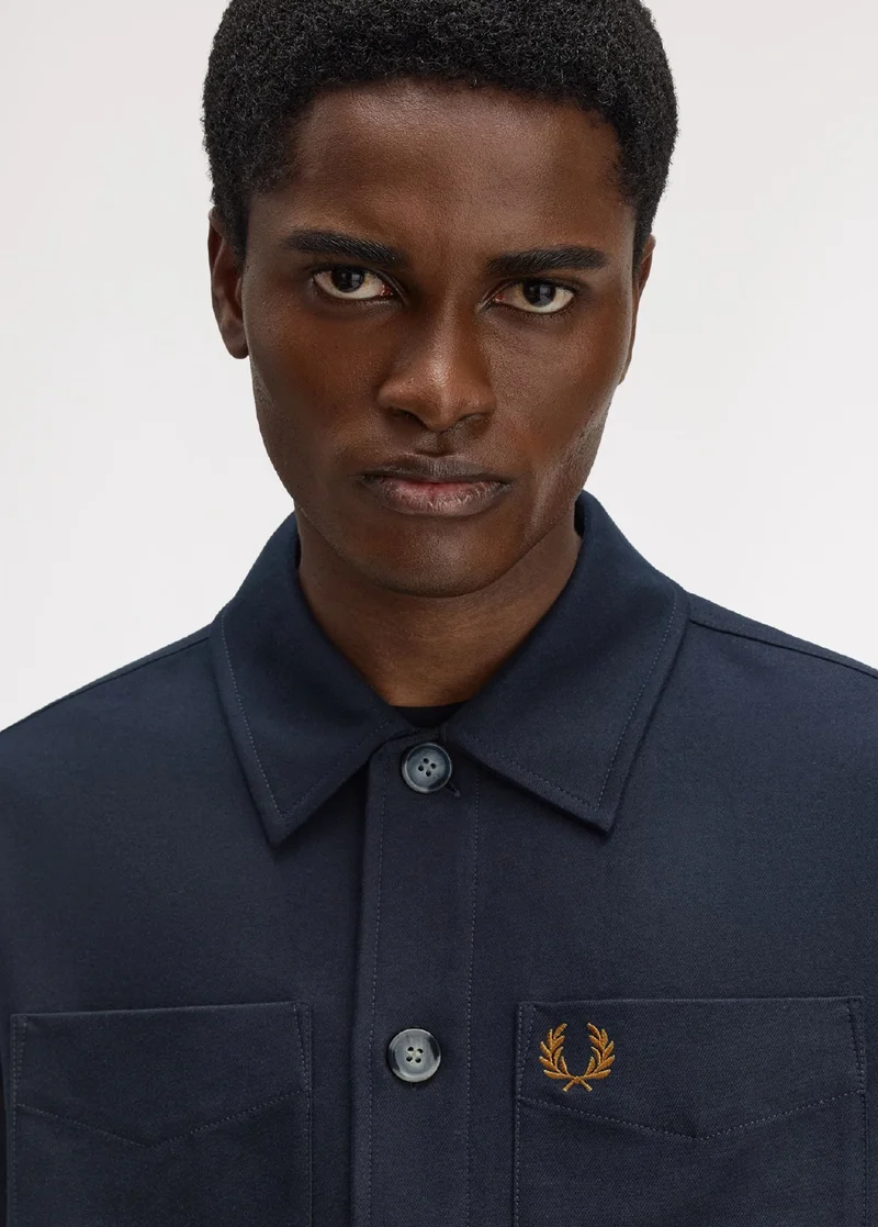 A male model wearing a Fred Perry Brushed Twill Overshirt in Navy
