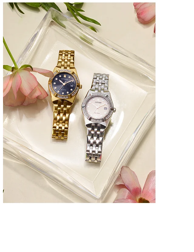 Corso Diamond EW2710-51X and EW2712-55E on a square glass place with flowers around it.