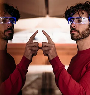 Man Wearing Smart Eyeglasses Using Touch Screen in Underground Walkway
