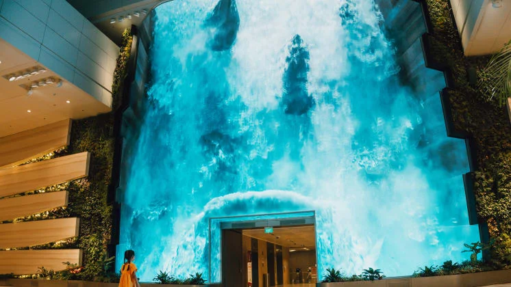 Be transported to a captivating realm as a grand digital waterfall descends at T2's departure hall