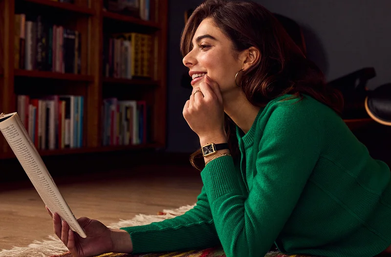 Woman reading a magazine and wearing the new Dress Classic