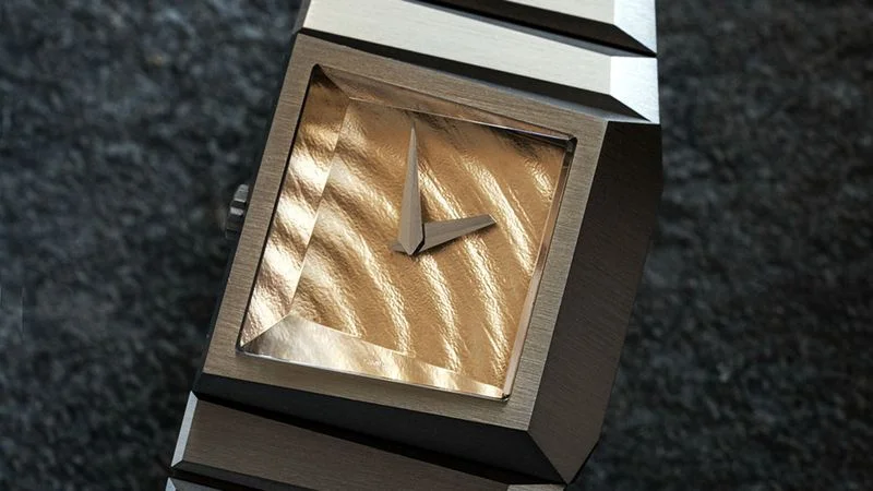 Image may contain: Wristwatch, Arm, Body Part, Person, and Mailbox