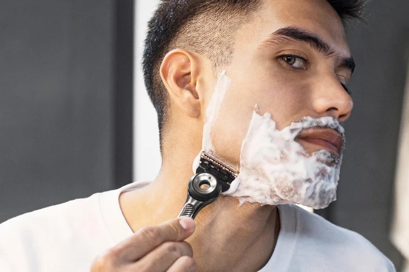 Man shaving his face with Gillette razor