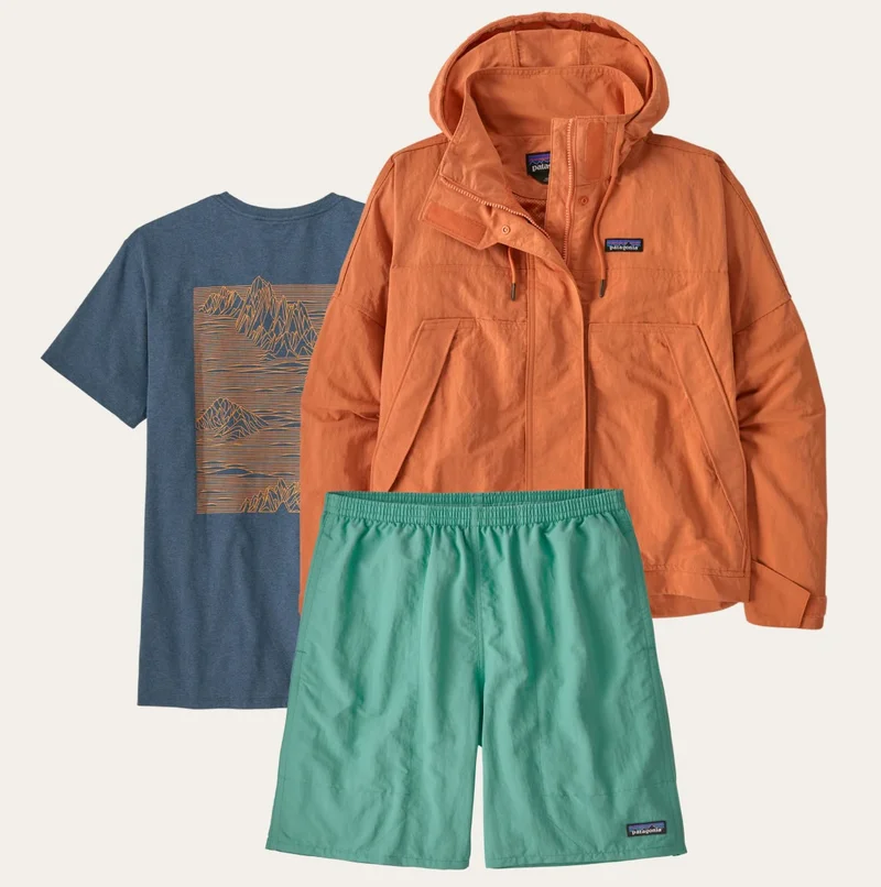 A laydown shot of a shirt, shorts and a jacket.