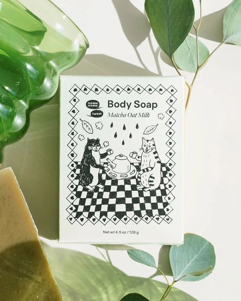 A BOX OF SOAP SITS ON A BACKGROUND WITH EUCALYPTUS