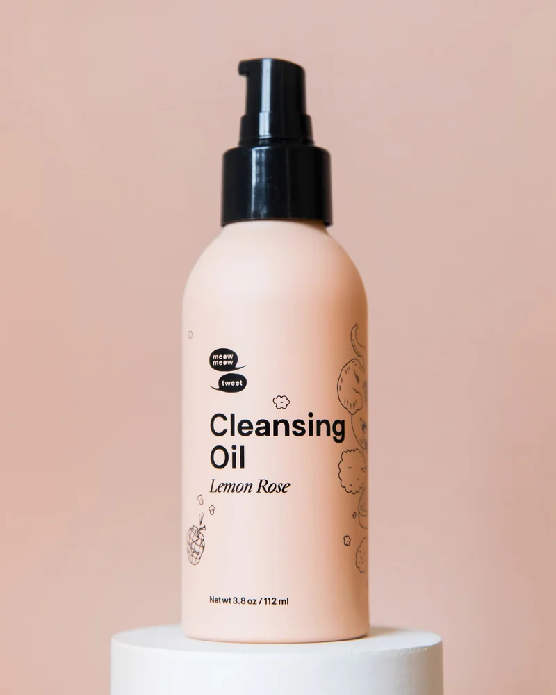 A PINK BOTTLE WITH A BLACK CAP