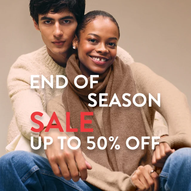 End-of-season sale: up to 50% off. A woman and man wearing cozy knitwear.
