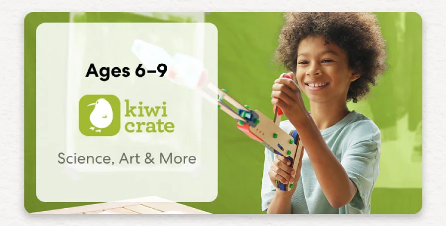Young child smiling while working on a science experiment from KiwiCo Labs. Hands-on STEM learning for ages 6–9