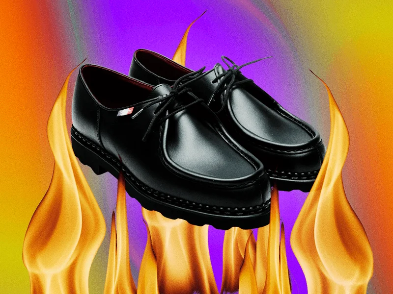 A pair of black Paraboot Michael mens shoes photoshopped over flames and a swirling background