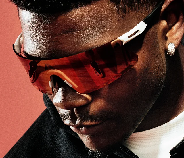 A close up portait of basketball player, Anthony Edwards, wearing red adidas sports sunglasses.