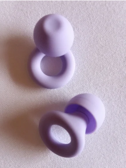 A pair of Violet Loop Quiet earplugs.