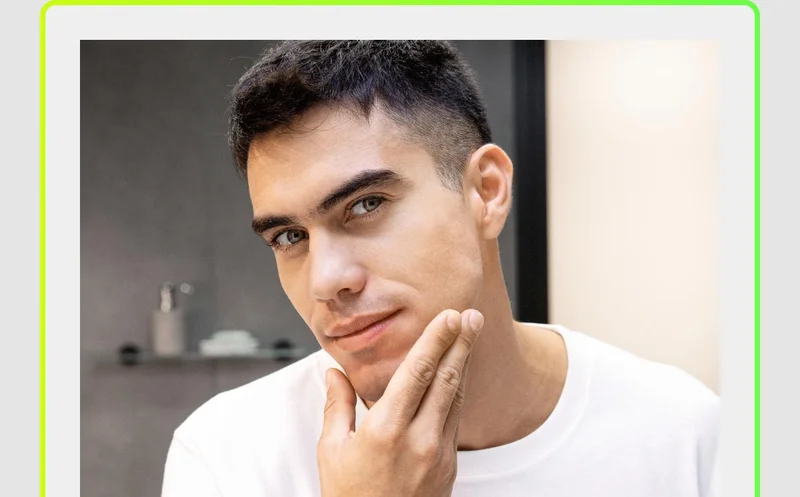 Young man touching his freshly shaven face
