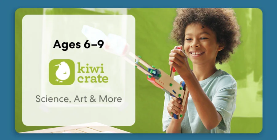 Young child smiling while working on a science experiment from KiwiCo Labs. Hands-on STEM learning for ages 6–9