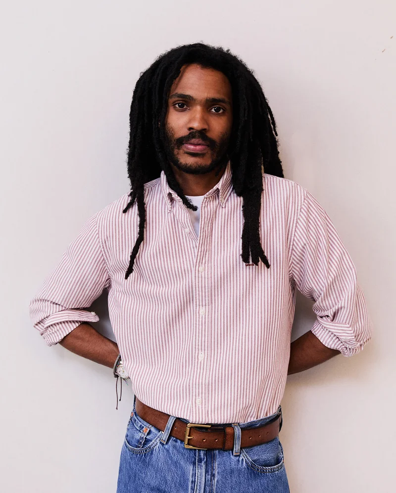 Man wearing a striped button up shirt.