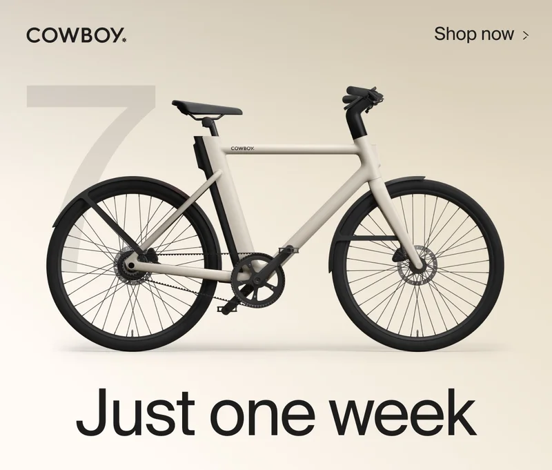 A graphic composition. A render of a Cowbiy Cruiser bike, seen from a low front-on angle, is positioned over the number 10. The Cowboy logo is in the top left and a Shop Now CTA in the top right corner.