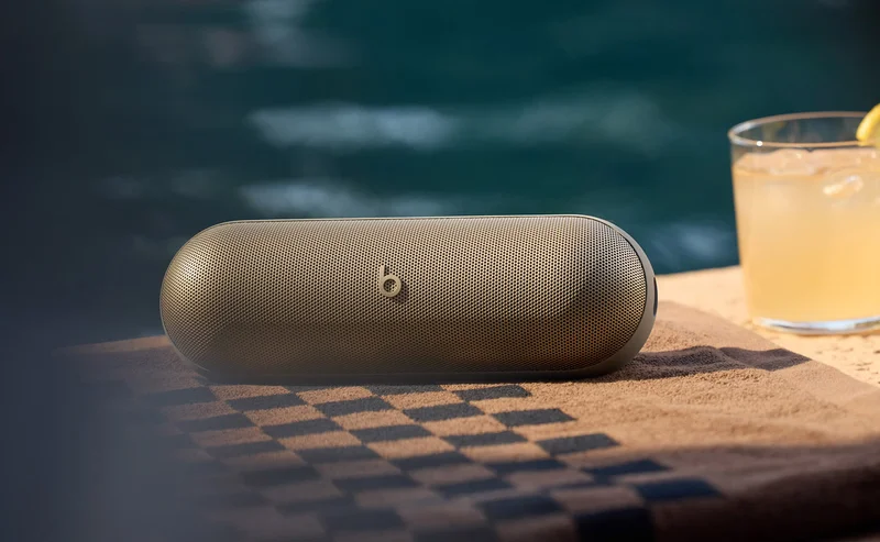 Beats Pill in Champagne Gold sitting poolside to demonstate water resistance.