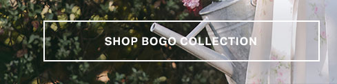 Silver watering can among green foliage and delicate floral patterns. Explore our discount code Collection sale for garden and home essentials.