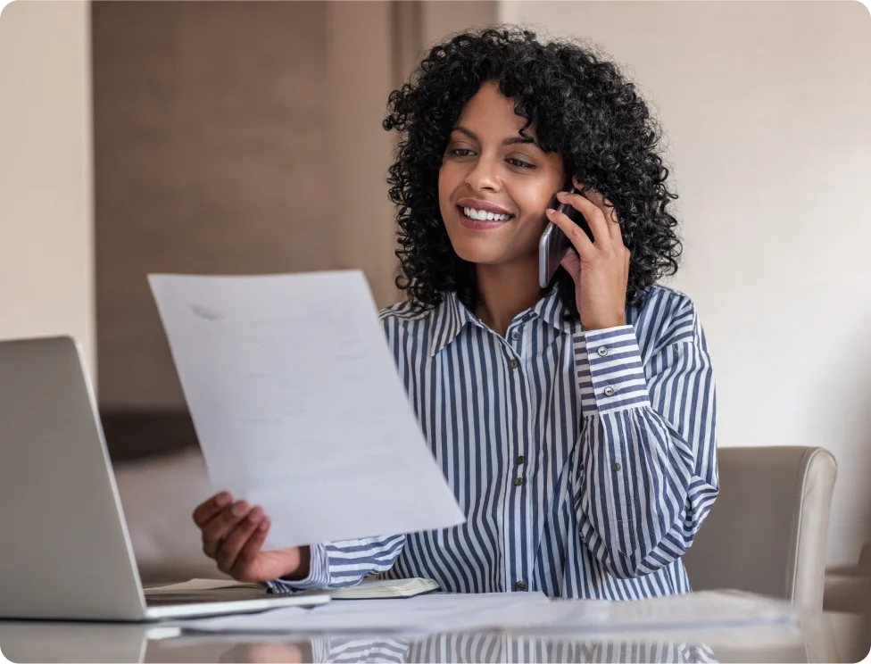 Person reviewing a document while on the phone