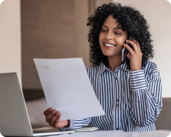 Person reviewing a document while on the phone