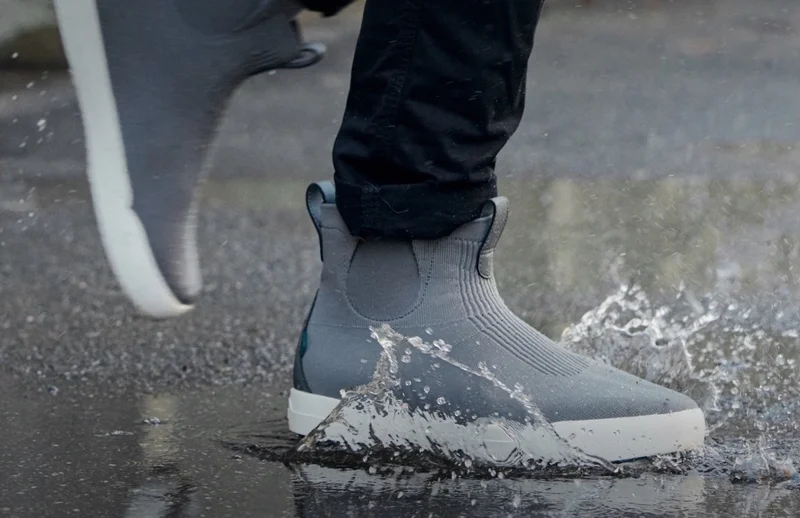 Hero graphic of someone stepping in a puddle wearing their Weekend Chelseas.