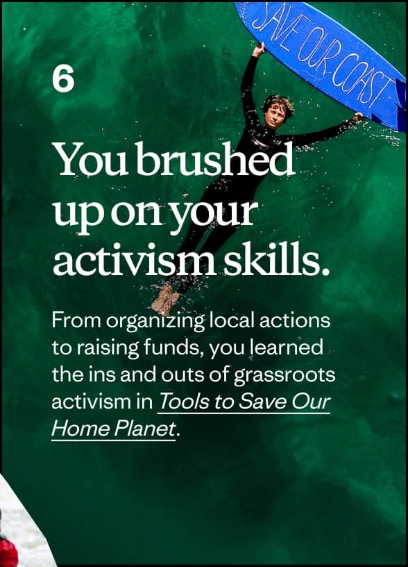 A person floats in the ocean holding a surfboard with “Save Our Coast” written on it.