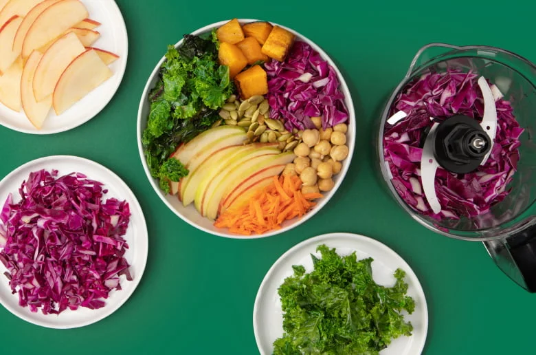 Bowl with a mix of salad, fruits, grains, and other healthy ingredients