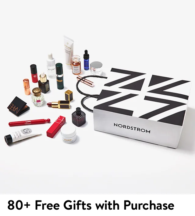 A collection of gift-with-purchase items spilling from a Nordstrom bag.