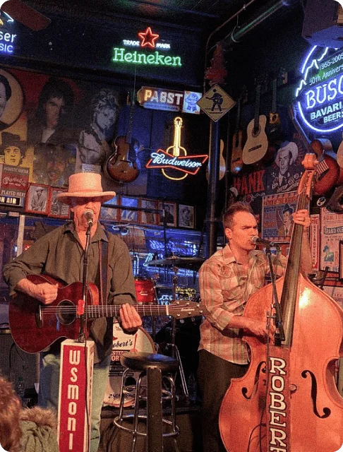 Image Description: A guitarist and standup bass player jamming to country music at a honky-tonk bar in Lower Broadway