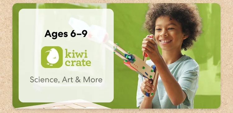 Young child smiling while working on a science experiment from KiwiCo Labs. Hands-on STEM learning for ages 6–9
