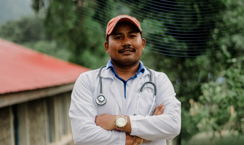 Photo of doctor in front of a Nepalese health clinic