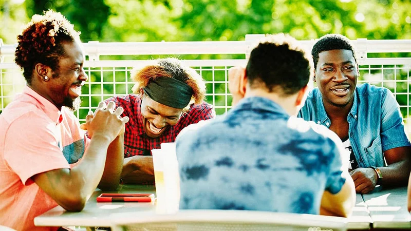 Image description: Group of friends eating outside on a sunny day