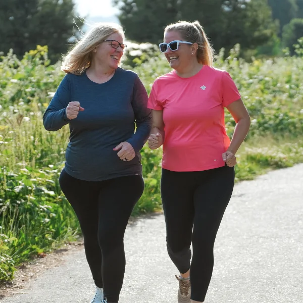 Two women running together
