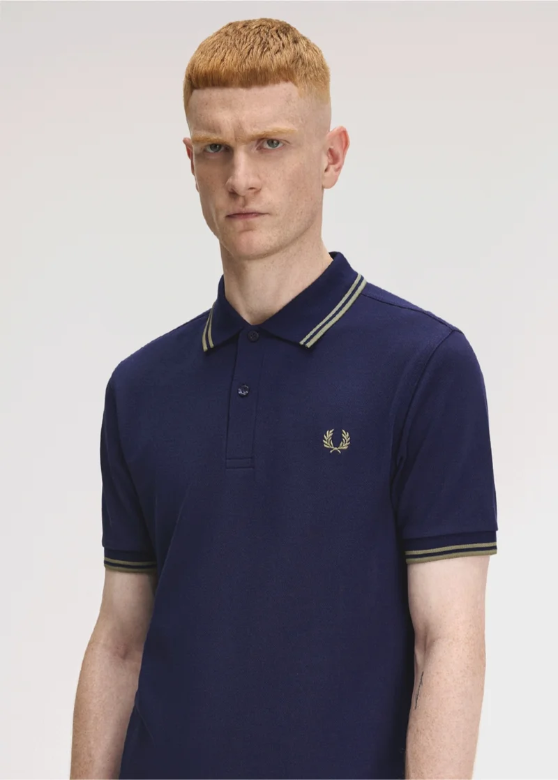 White male model wearing a French Navy and Olive Mint M3600 Fred Perry Shirt