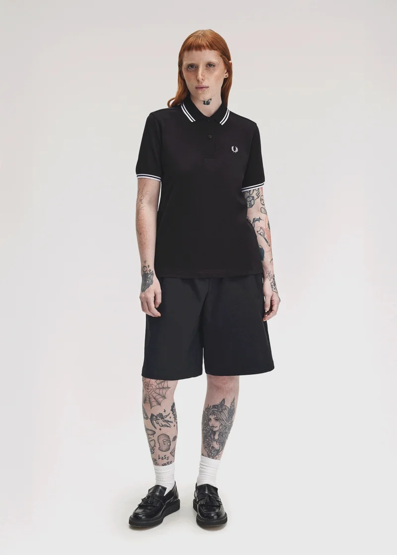 White female model wears a G3600 Black Fred Perry Shirt