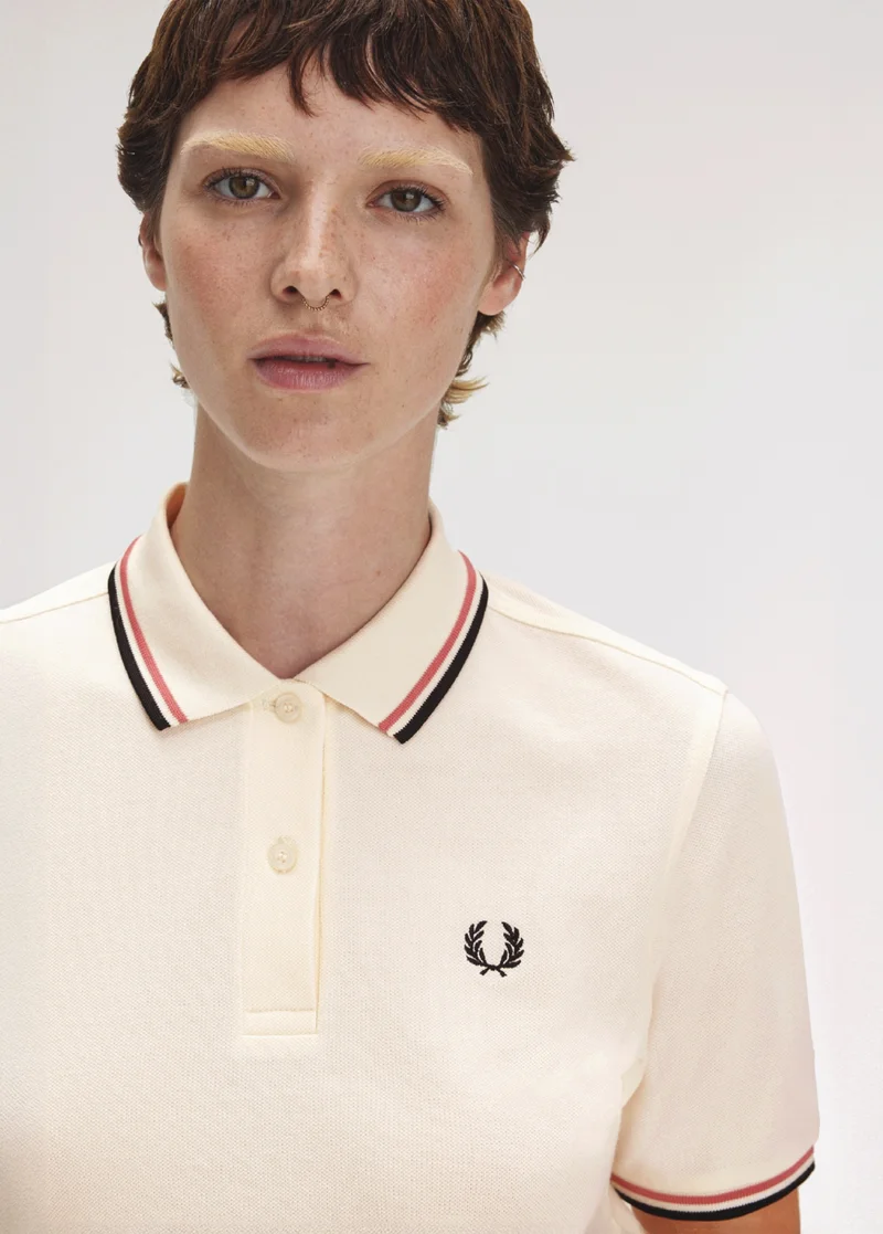 White female model wears a G3600 Fred Perry Shirt
