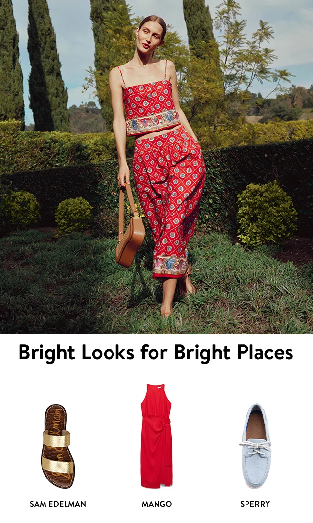 A woman wearing a floral-print top with a matching skirt. A gold slide sandal, red dress and blue loafer.
