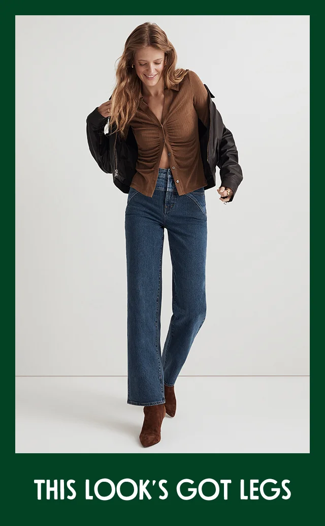 A woman wearing jeans with a brown top, jacket and boots.