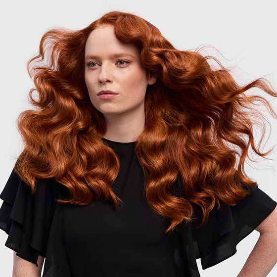 Model curling hair with the conical barrel attachment.