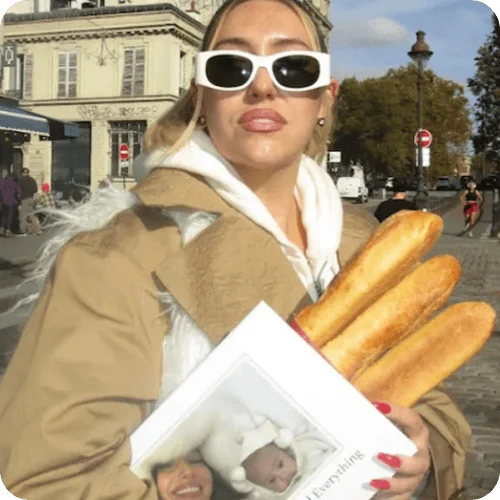 DJ madbadting carrying baguettes and a Tinybeans photo book for moms DJ madbadting carrying baguettes and a Tinybeans photo book for moms