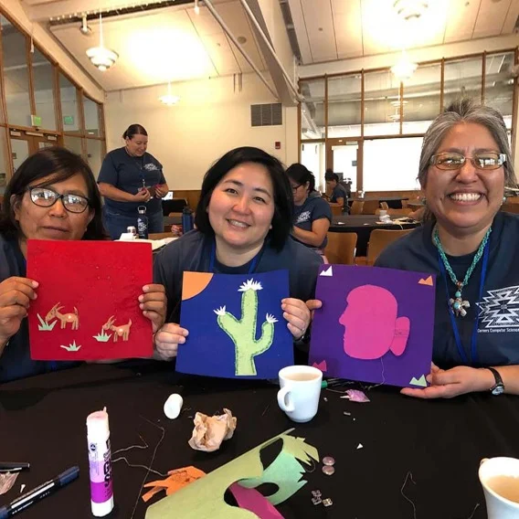 three people displaying their wor