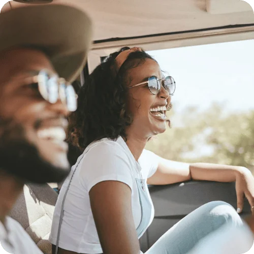 a happy couple driving and laughing a happy couple driving and laughing