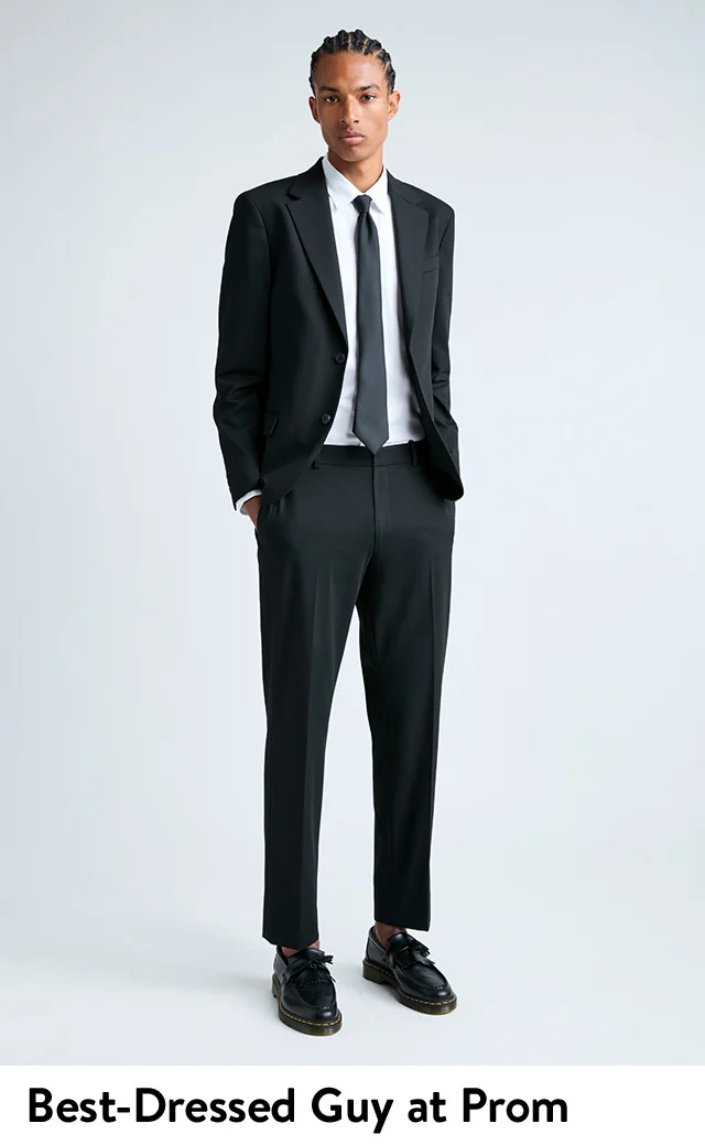 A young man wearing a slim sport coat and pants from Open Edits with Dr. Martens loafers.