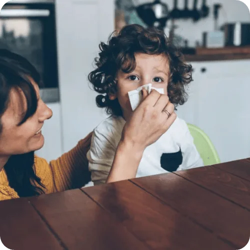a mom helping to treat her sick kid's cold and flu with products recommended by a pediatric er doctor